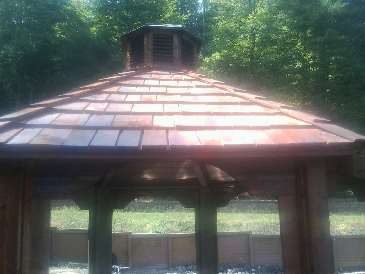New cedar shake roof and cupola on a lakeside gazebo in Ashland